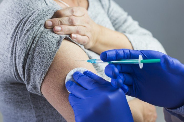 close-up-of-doctor-s-hand-wearing-blue-gloves-giving-syringe-on-patient-s-arm.jpg