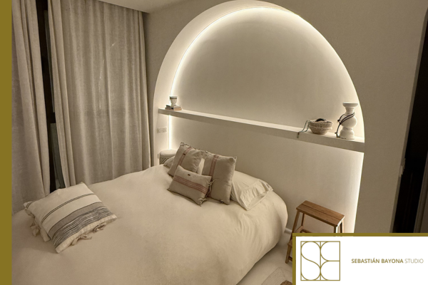 Contemporary elegant and relaxing bedroom with warm textiles, soft lighting, and refined materials.