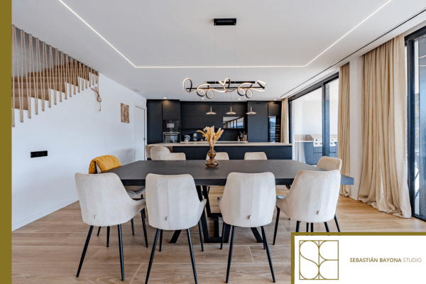 Contemporary elegant and functional dining room with a well-proportioned table, warm lighting, and refined materials.