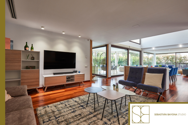 Terrace with pool and covered outdoor dining area designed to make the most of natural light and garden views.